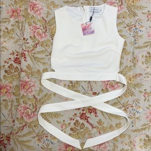 White dressy crop top. Ties around waste.